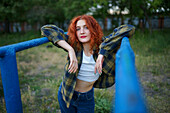 Redhaired woman posing at playground