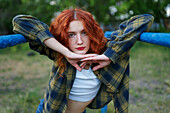 Redhaired woman posing at playground
