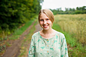 Portrait of smiling woman standing in field