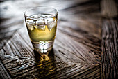 Close-Up of a Chilled Whiskey Shot on Wood