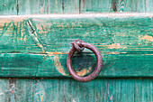 Faiyum, Egypt. Iron ring on a green painted wooden gate.