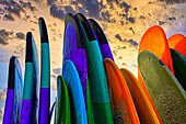 Stacked surf boards at sunset after a day of surf school in Canggu, Bali, Indonesia