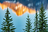 Canada, Alberta, Banff National Park. Peaks of Mt. Rundle reflected in Two Jack Lake at sunrise.