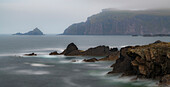 Ireland, Ferriter's Cove. Ocean and cliff in misty landscape.