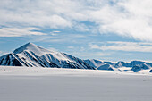 Snow streaked mountains on the island of Spitsbergen. Near Mushamna, Spitsbergen Island, Svalbard, Norway.