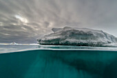 An over-under view of an iceberg. Vibebukta, Austfonna, Svalbard, Norway