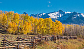 USA, Colorado, Quray. Dallas Divide, Sonnenaufgang auf dem Mt. Snaffles mit Herbstfarben und Split Rail Zaun