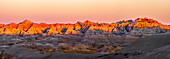 USA, South Dakota, Badlands National Park. Panoramic of sunrise on arid park formations.