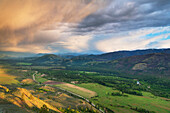Storm clouds glowing from setting sun over Methow Valley, North Cascades, Washington State