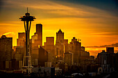 USA, Washington State, Seattle. Dawn on Seattle skyline from a park on Queen Anne Hill with Mt. Rainier in the background.