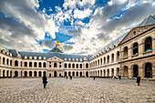 A large courtyard with a clock tower at Les Invalides in Paris, France.