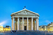 The Panthéon's neoclassical facade stands illuminated at dusk.
