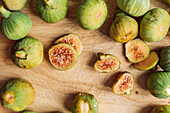 Ripe sweet green figs, freshly harvested from domestic tree on wood cutting board. Also known as ripe white figs