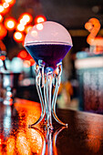 Low angle of refreshing flavor blaster cocktail in glass served on counter in bar