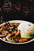 Appetizing cooked Yuxiang eggplant with healthy vegetables and rice on white plate in Asian restaurant