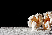 Closeup of a delicious popcorn on a layer of salt