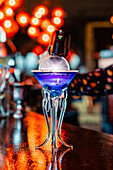 Low angle of refreshing flavor blaster cocktail in glass served on counter in bar