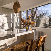 Interior of dining zone in cozy light kitchen