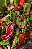 Top view of delicious salad with arugula and quince