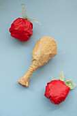 Plastic bags artistically arranged to resemble food items against a blue backdrop, highlighting issues of plastic waste and environmental consciousness.