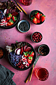 Purple and red salad bowl with strawberries