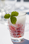 Strawberries in wine foam with mint