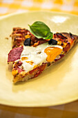 Pizza with fried egg and basil leaf