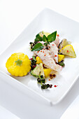 Sea bream fillet with colourful vegetables and herbs