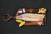 Raw pike-perch fillet on wooden board