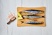 Raw smelts on a wooden board