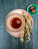Sour Asian broth with umeboshi and deep-fried asparagus