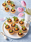 Mini tarts with chocolate filling and marzipan carrots