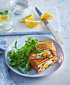 Grilled mackerel sandwich with egg and rocket salad