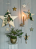 Christmas wall decoration with stars and small fir tree in a pot