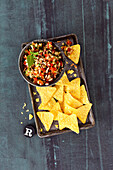 Colourful salad dip with tortilla chips