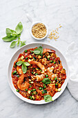 Oat and tomato risotto with prawns and peas