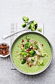 Broccoli soup with smoked trout and almonds