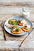 Carrot pancakes with smoked fish and horseradish sauce