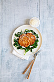 Ricotta pancakes on spinach with parmesan