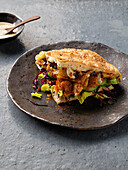 Tempeh sandwich with vegetables and tahini sauce