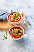 Tomato soup with herb dumplings and fresh herbs
