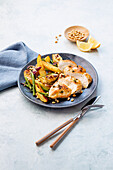 Lemon chicken with jacket potatoes and green beans