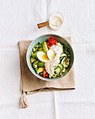 Millet bowl with egg, avocado and yoghurt dressing