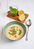 Lemon and parmesan soup with chicken and rocket oil
