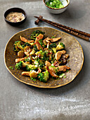 Wok vegetables with teriyaki chicken and spring onions