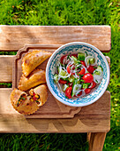 Empanadas with beef, tomato and cucumber salad