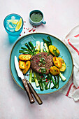 Beef steak with roast potatoes and spring onions
