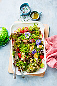 Spring salad with lemon vinaigrette and edible flowers