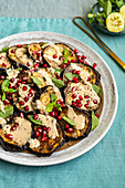 Oriental aubergine salad with hummus and pomegranate seeds