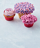 Cupcake arrangement with flower pattern, pastel colours